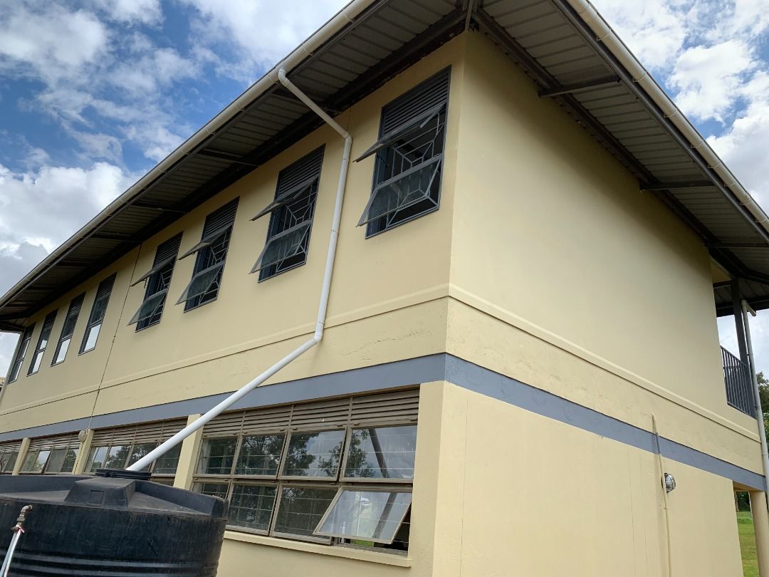 Completed block: upper-floor windows and rainwater downpipes